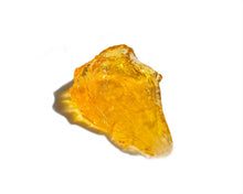 Load image into Gallery viewer, Close-up of the golden amber texture of Suavecito Firme Strong Hold Pomade.