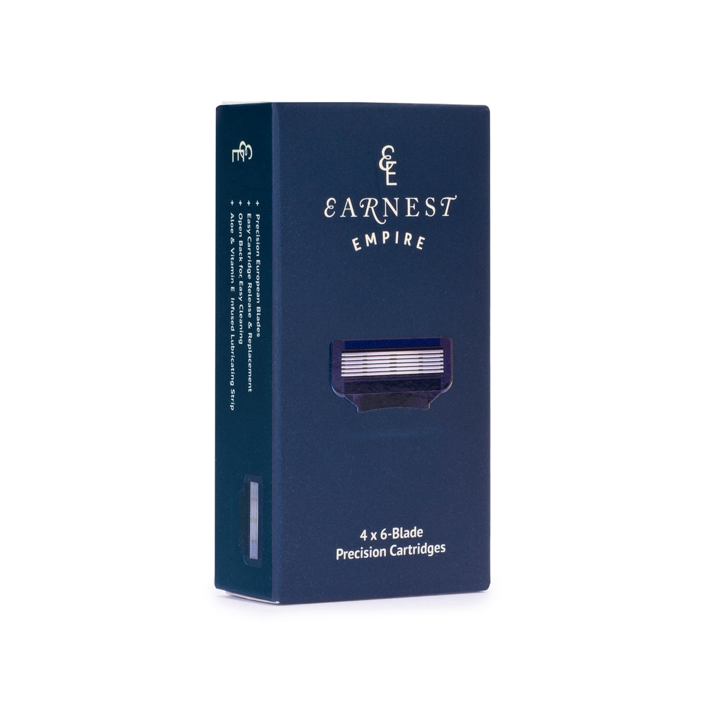 Front of the navy Earnest Empire refill box labelled four six-blade precision cartridges.