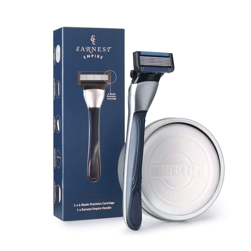 Earnest Empire Premium Shaving Starter Kit with an upright razor, navy box and BarberShopCo shave soap in a silver tin.