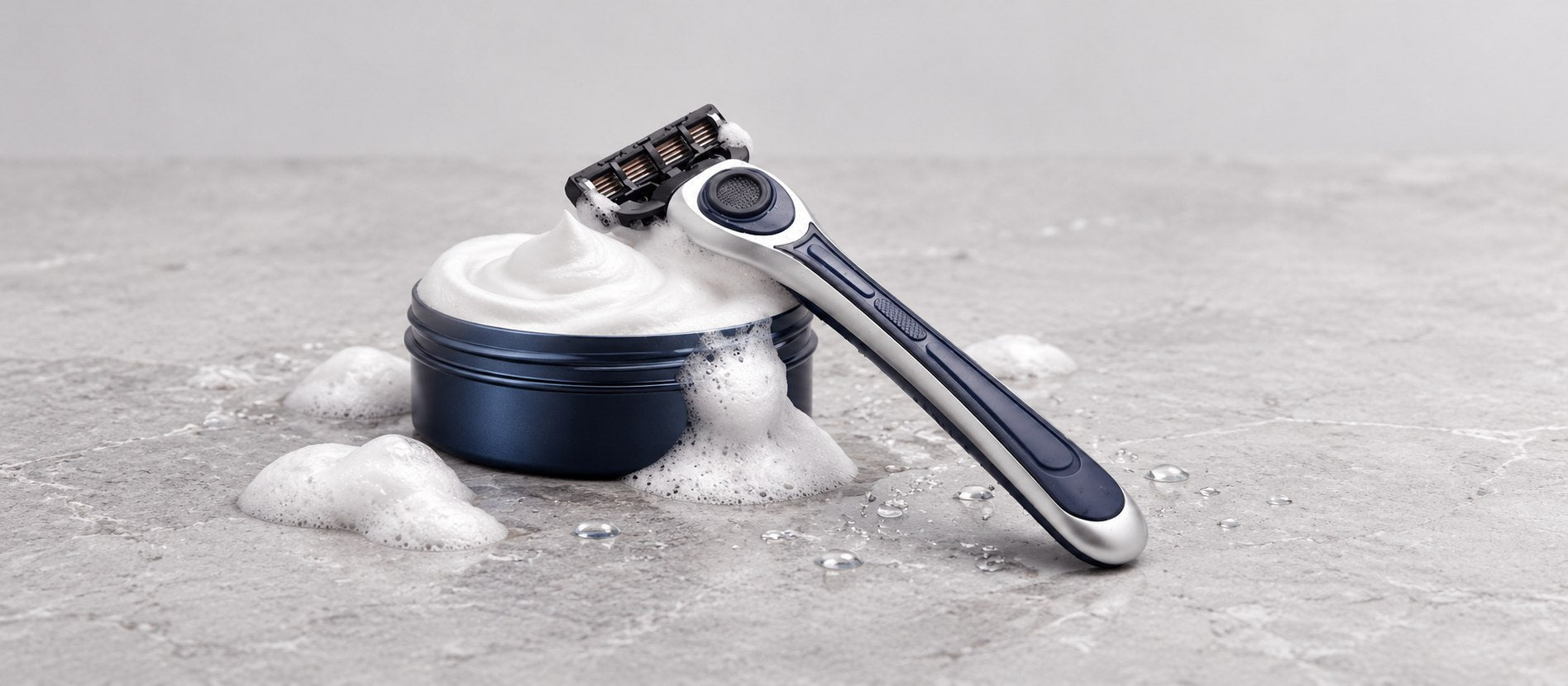 Earnest Empire razor and BarberShopCo shave soap arranged on a stone surface
